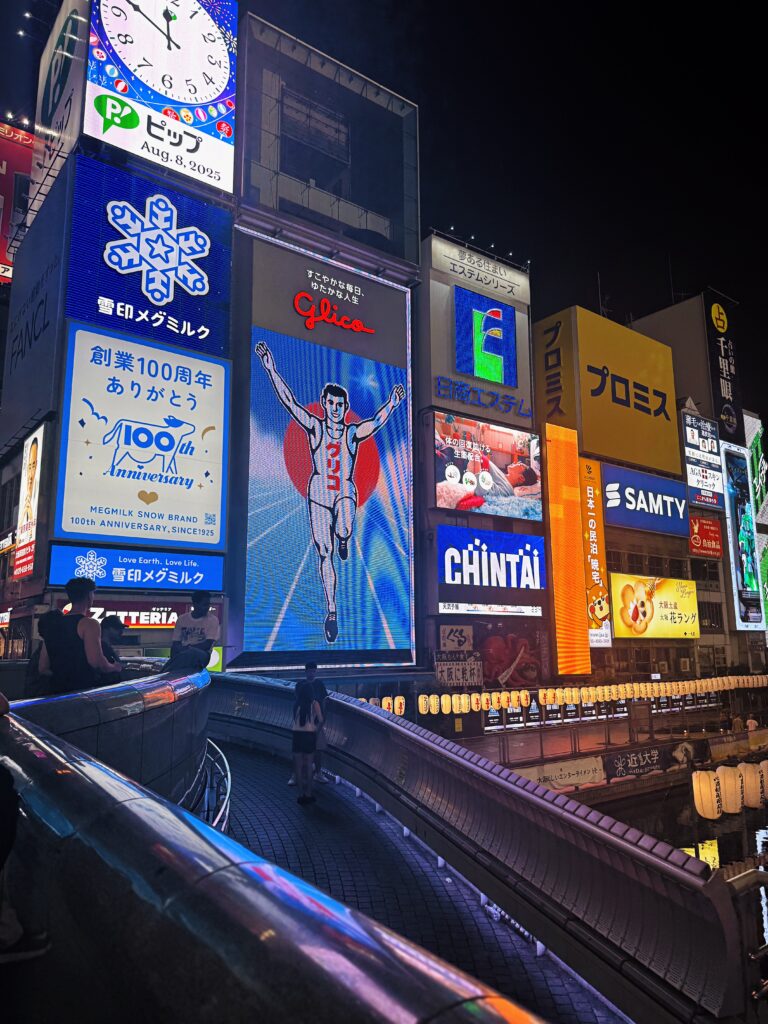 A nightime shot of the famous Glico Running Man billboard in downtown Osaka. The man has stood there for over 80 years. Crazy.